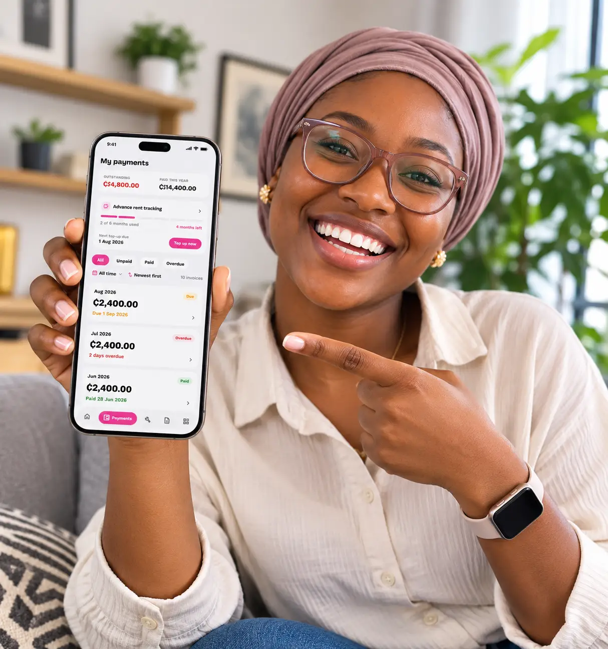 A tenant pointing at her advance rent tracker in the Yiliora app